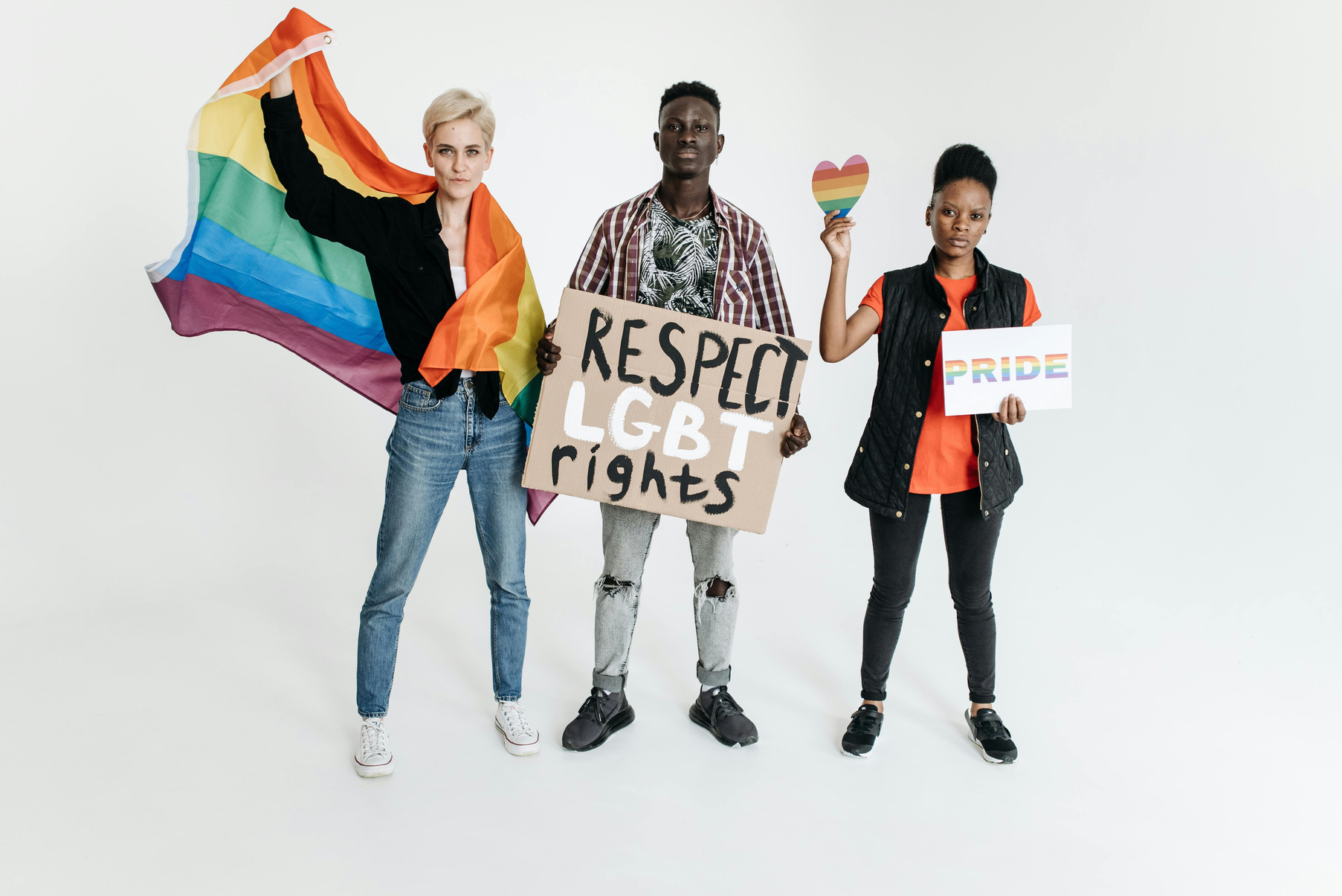 three people holding signs that say respect lgbt rights